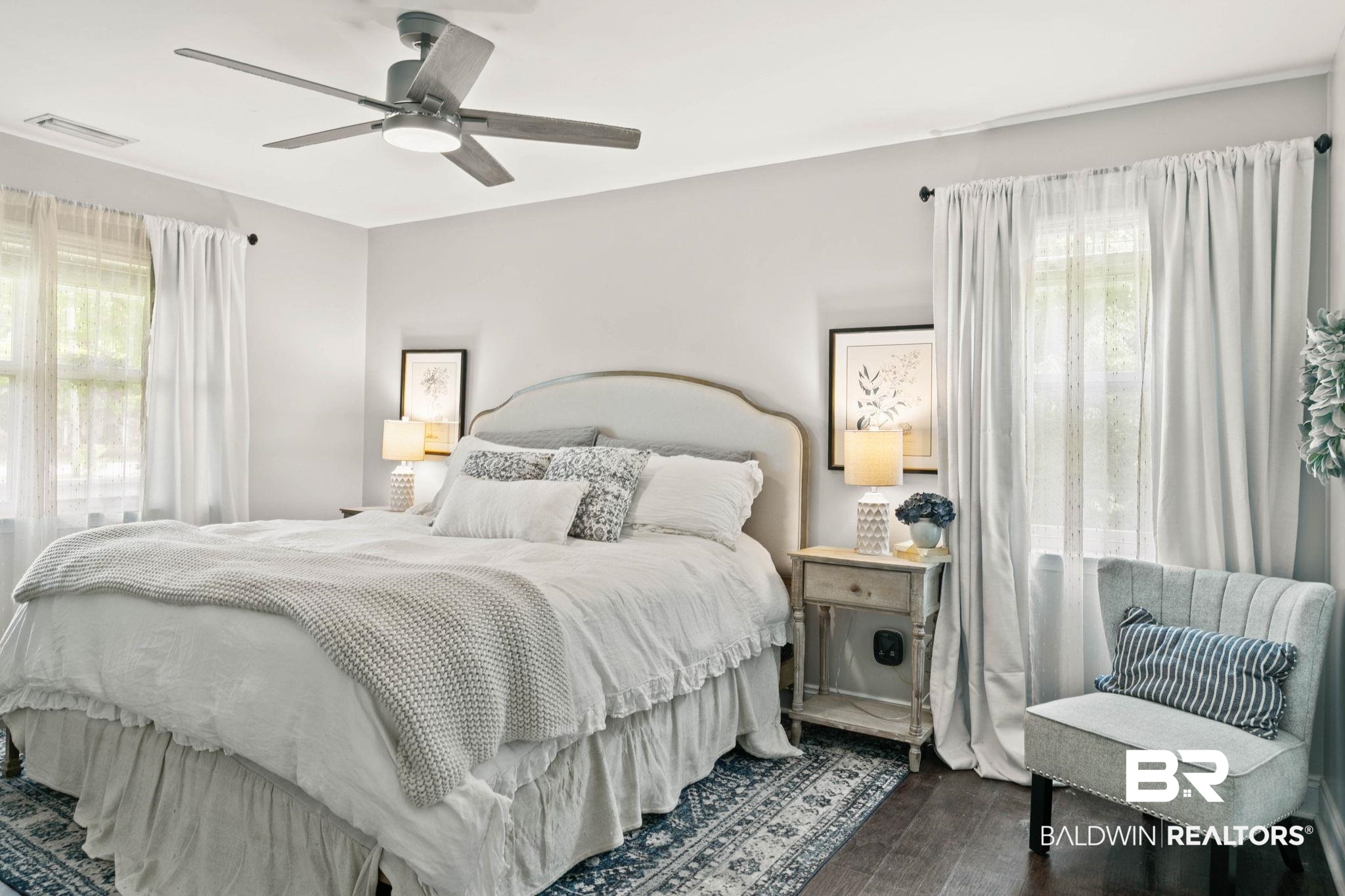 22810 High Ridge Road Fairhope, AL 36532 - Photo 33 of 78 Spacious room featuring wood-finish flooring, a contemporary ceiling fan with integrated lighting, and multiple windows with curtain rods