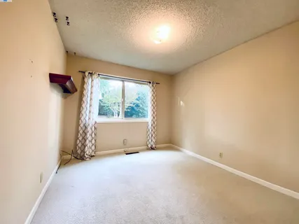 a bedroom with a bed and lamp