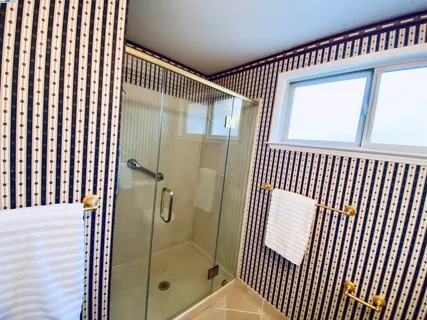 a spacious bathroom with a mirror sink and toilet