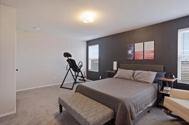 a bedroom with bed and window