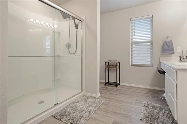 a bathroom with a shower and a mirror