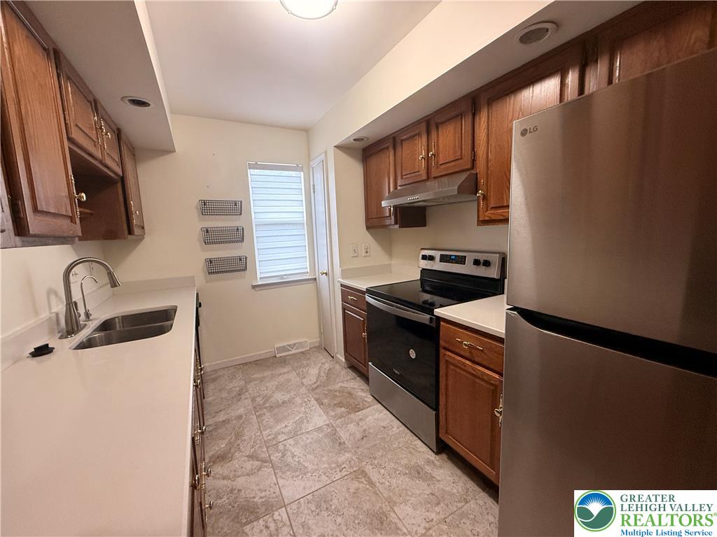 170 Springhouse Road Allentown, PA 18104 - Photo 8 of 23 A well-appointed kitchen features rich wooden cabinetry and contemporary stainless steel appliances.