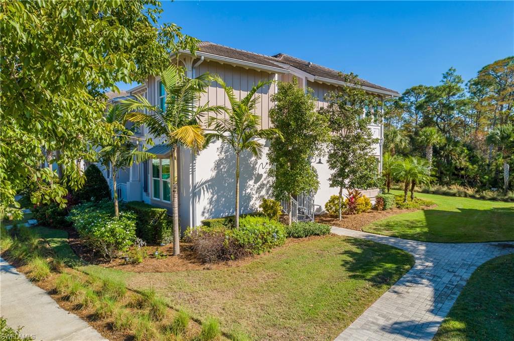 6552 Dominica Drive, Unit 101 Naples, FL 34113 - Photo 45 of 50 a view of a house with a yard and tree s