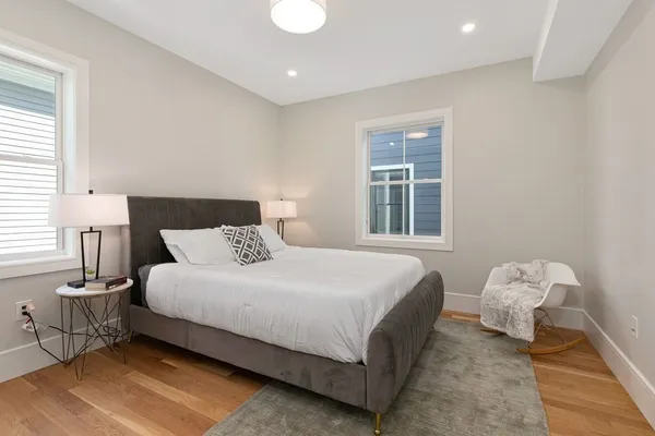 a bedroom with a bed and wooden floor