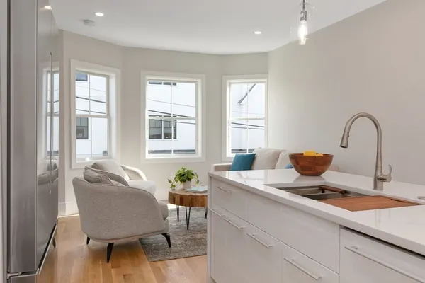 a kitchen with a table chairs and a window