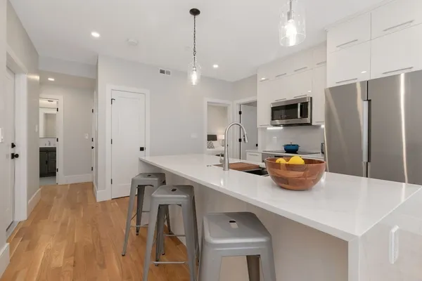 a kitchen with stainless steel appliances a sink refrigerator and microwave