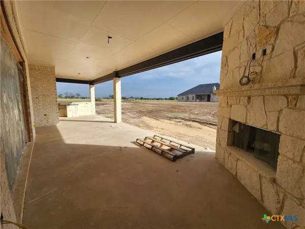 a view of an empty room with a fireplace