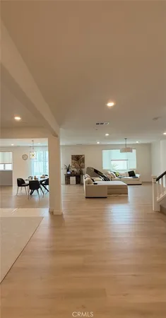 a room with lots of furniture and view of kitchen