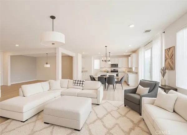 a living room with furniture and a chandelier
