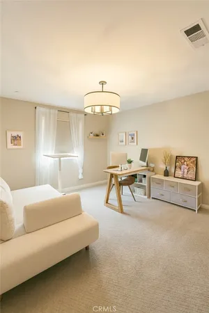a living room with furniture and a lamp