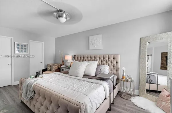 a bedroom with bed and wooden floor