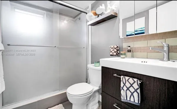 a bathroom with a sink a toilet and mirror