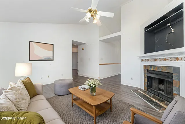 a living room with furniture and a fireplace