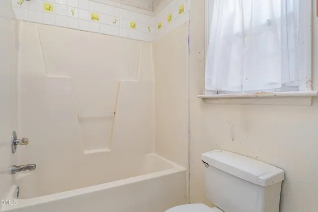 a bathroom with a toilet and a bathtub
