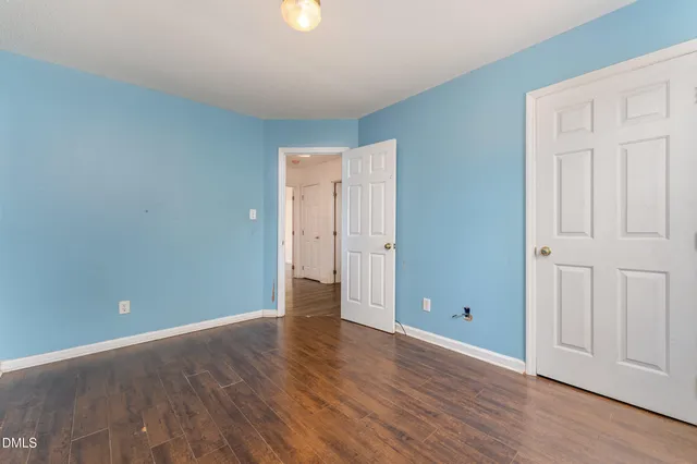 a view of an empty room and wooden floor