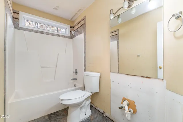 a bathroom with a toilet sink and shower