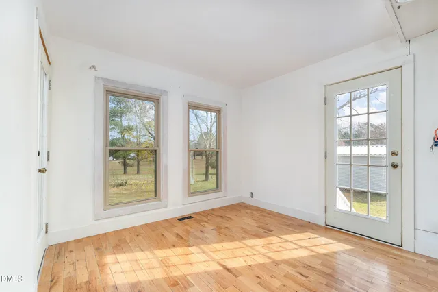 a view of a bedroom with a balcony and a bed