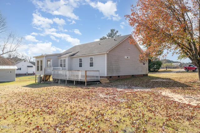 a backyard of a house with barbeque oven table and chairs