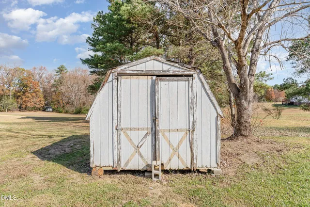 a backyard of a house with a small yard and wooden fence