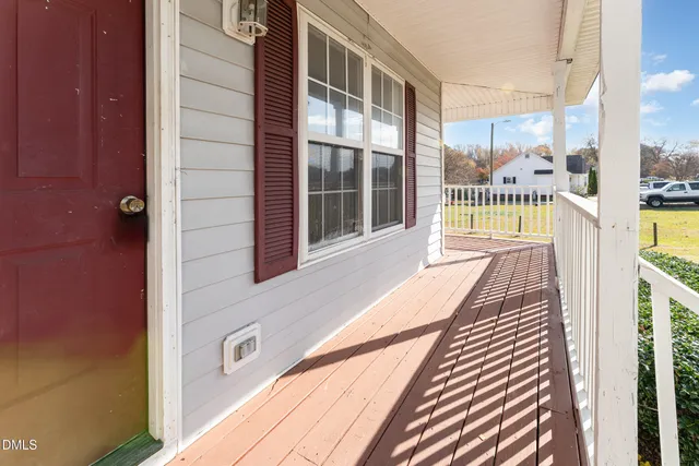a view of a balcony with wooden floor
