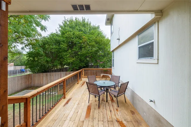 a balcony view with two chairs and a table