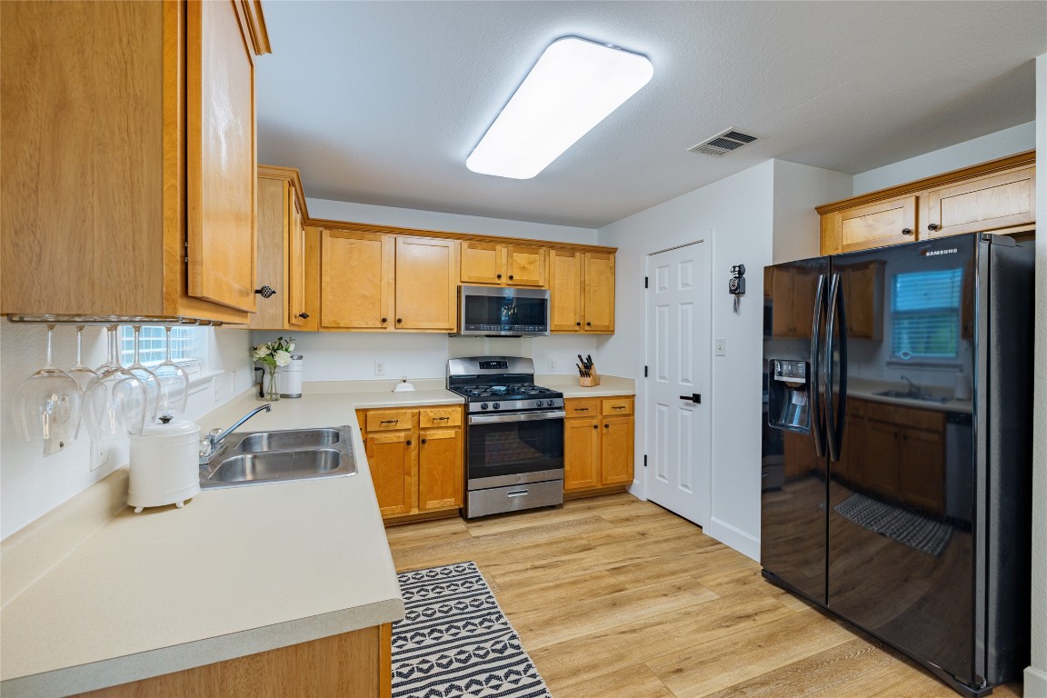 1130 Sundrop Place Round Rock, TX 78665 - Photo 6 of 18 a kitchen with stainless steel appliances granite countertop a refrigerator stove and sink