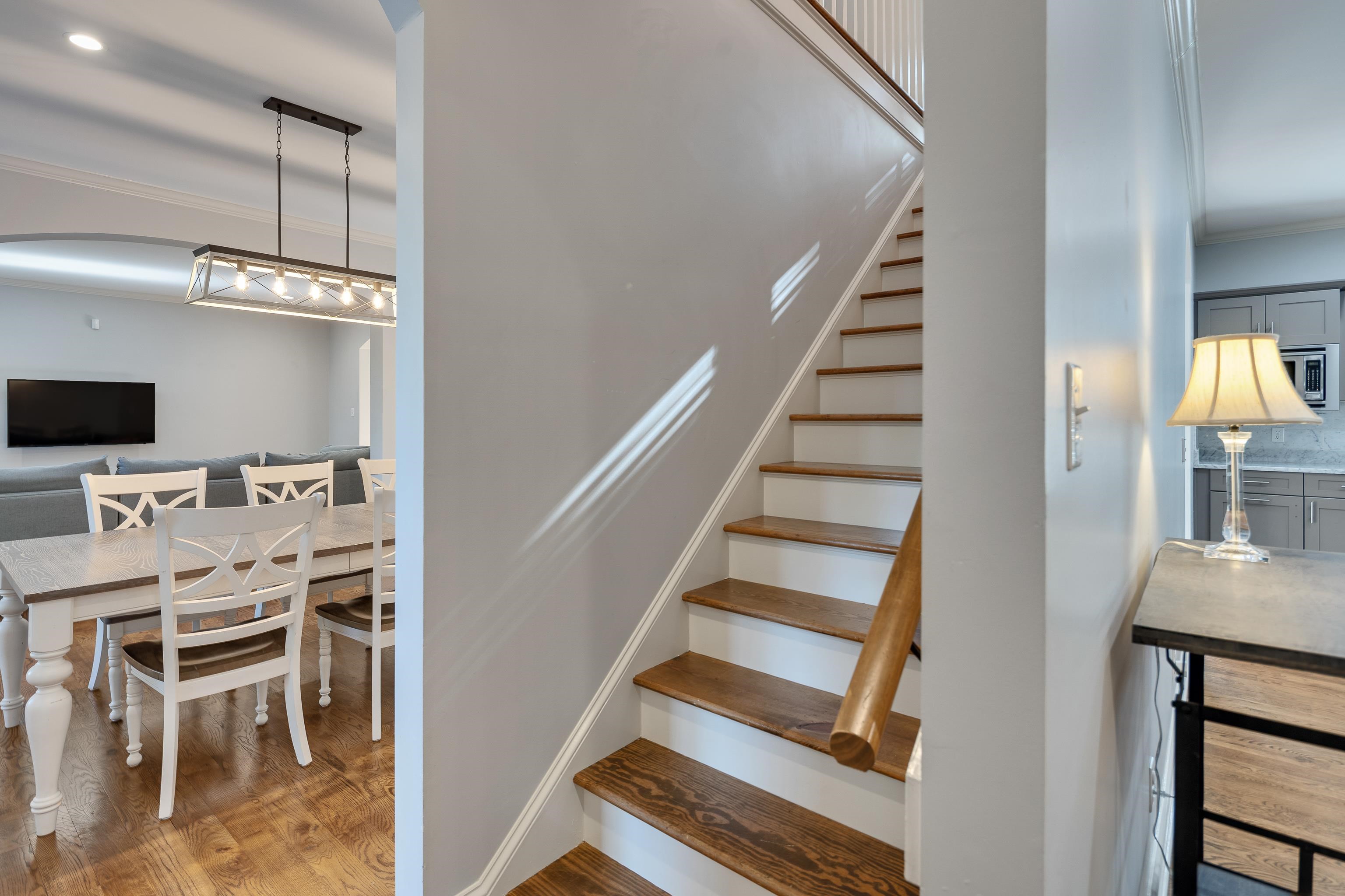 237 Windover Road Memphis, TN 38111 - Photo 22 of 37 Stairs featuring ornamental molding, wood finished floors, and arched walkways