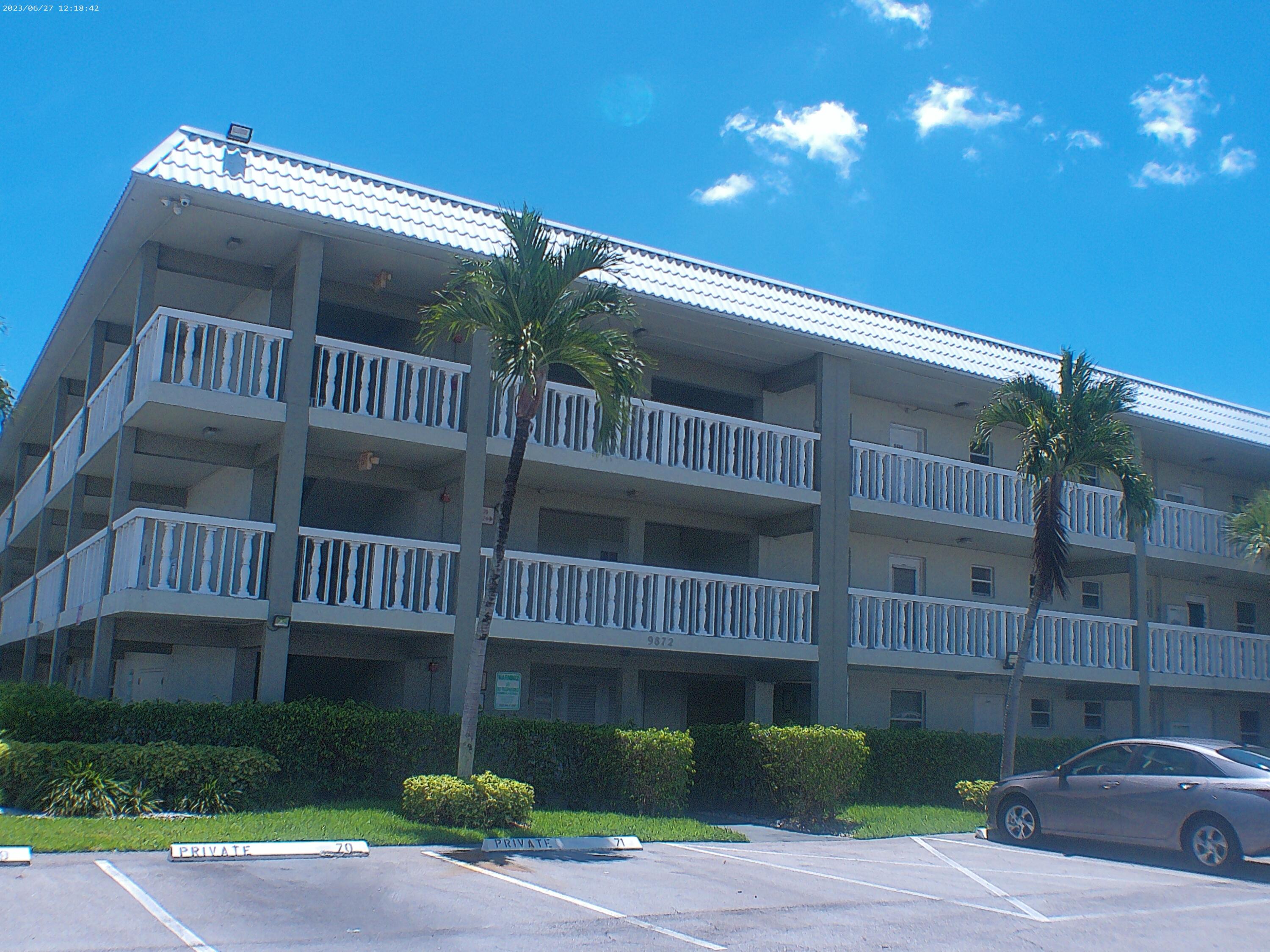 9872 Marina Boulevard, Unit 1434 Boca Raton, FL 33428 - Photo 2 of 63 a view of a house with a yard and deck