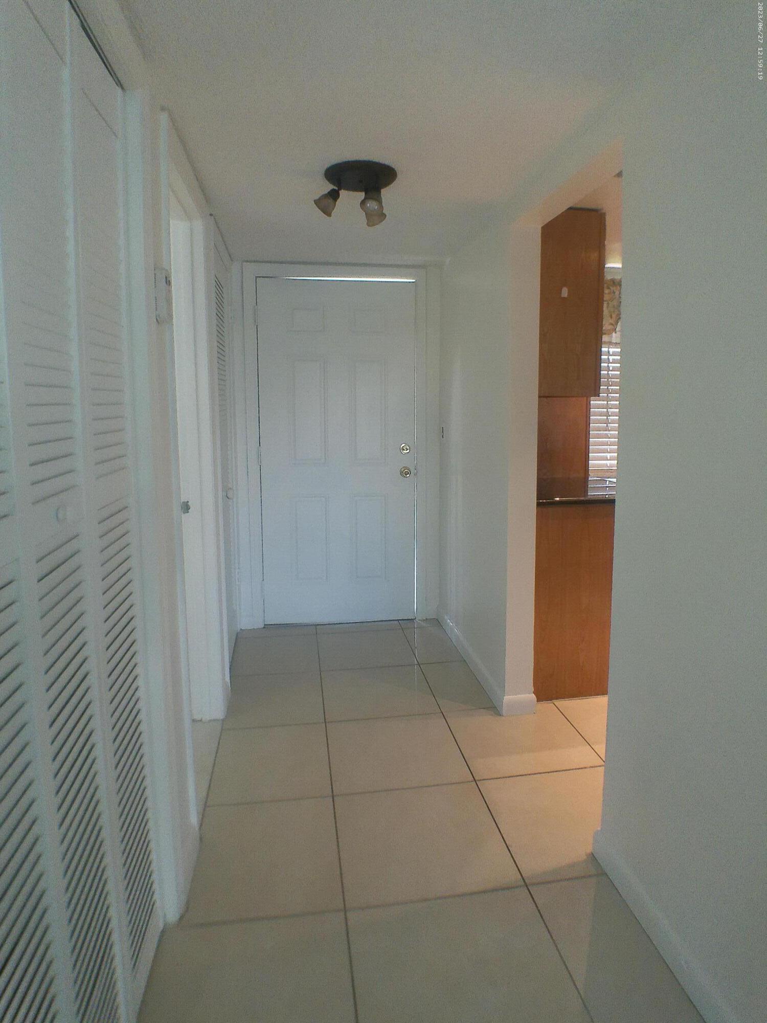 9872 Marina Boulevard, Unit 1434 Boca Raton, FL 33428 - Photo 26 of 63 a view of hallway with wooden floor
