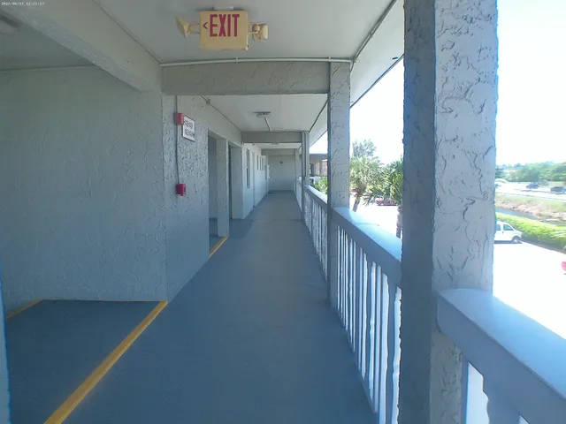 a kitchen with granite countertop a refrigerator and a stove top oven