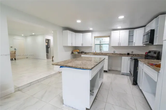a kitchen with a sink stove and refrigerator