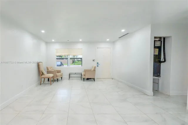 a living room with furniture and white walls