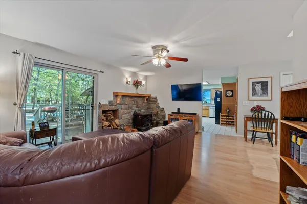 a kitchen that has a table chairs and a refrigerator