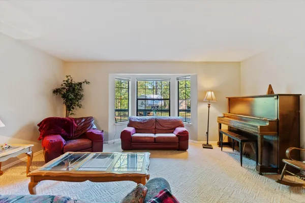 a view of a livingroom with workspace and a window