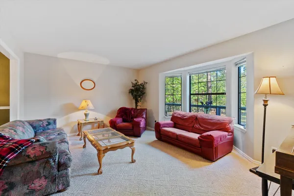 a view of a livingroom with workspace and a window