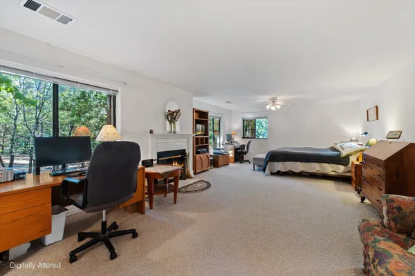 a bedroom with a bed and a large mirror