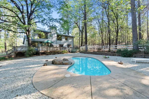 a swimming pool with outdoor seating and yard