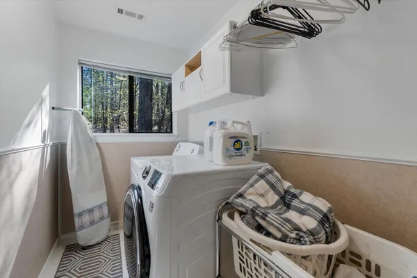 a view of dirt yard with a large tree