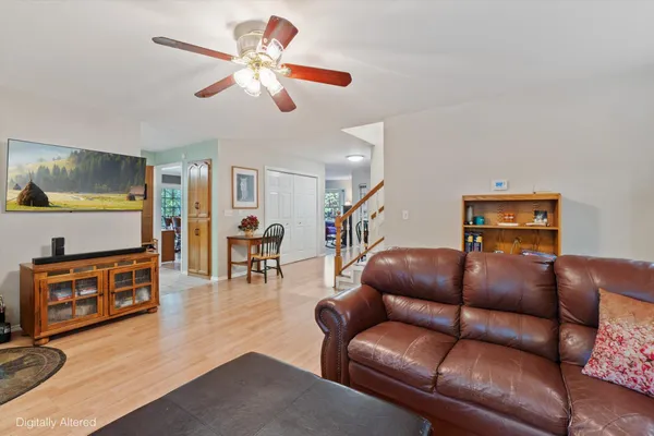 a living room with furniture a fireplace and a large window