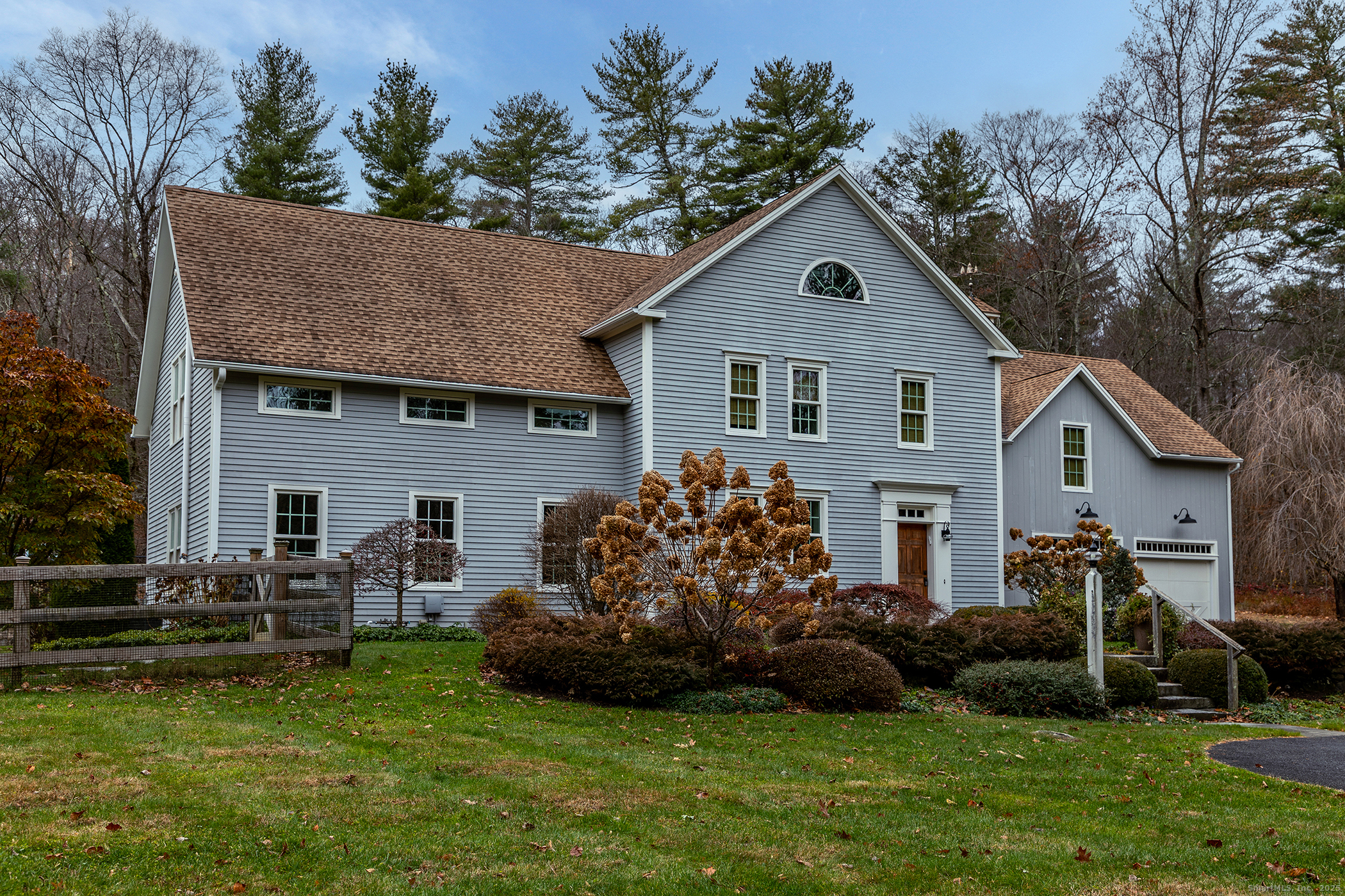 a front view of house with yard and green space