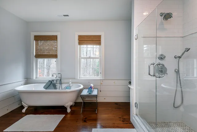 a spacious bathroom with a bathtub and shower