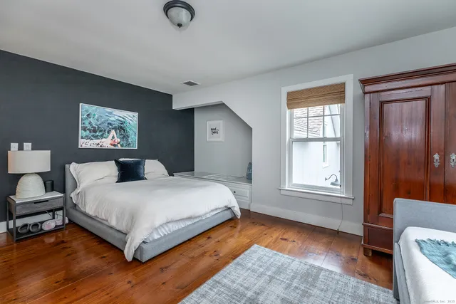 a spacious bedroom with a bed and window