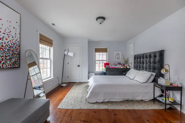 a bedroom with a bed and window