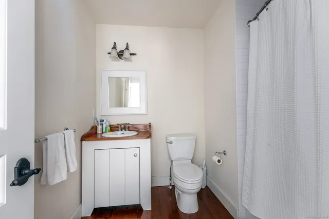 a bathroom with a sink a mirror and a toilet