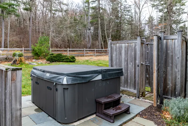 a view of a backyard with chairs and a small cabin