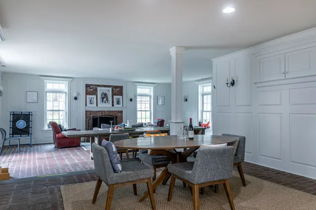 a living room with furniture a fireplace and a window