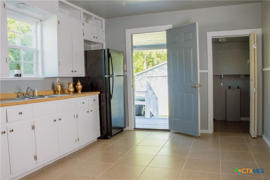 1407 South 7th Street Temple, TX 76504 - Photo 11 of 36 a kitchen with stainless steel appliances a refrigerator sink and cabinets