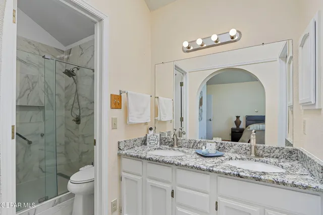 a bed sitting in a bedroom next to a window and a lamp