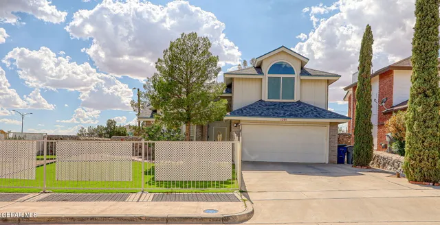 a front view of a house with a garden and plants
