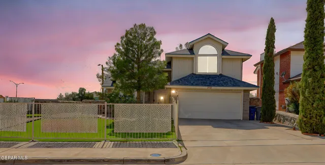 a front view of a house with a garden and plants